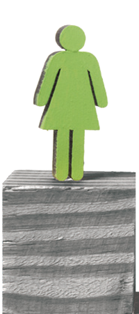 A cut-out figure in a dress on a wooden block
